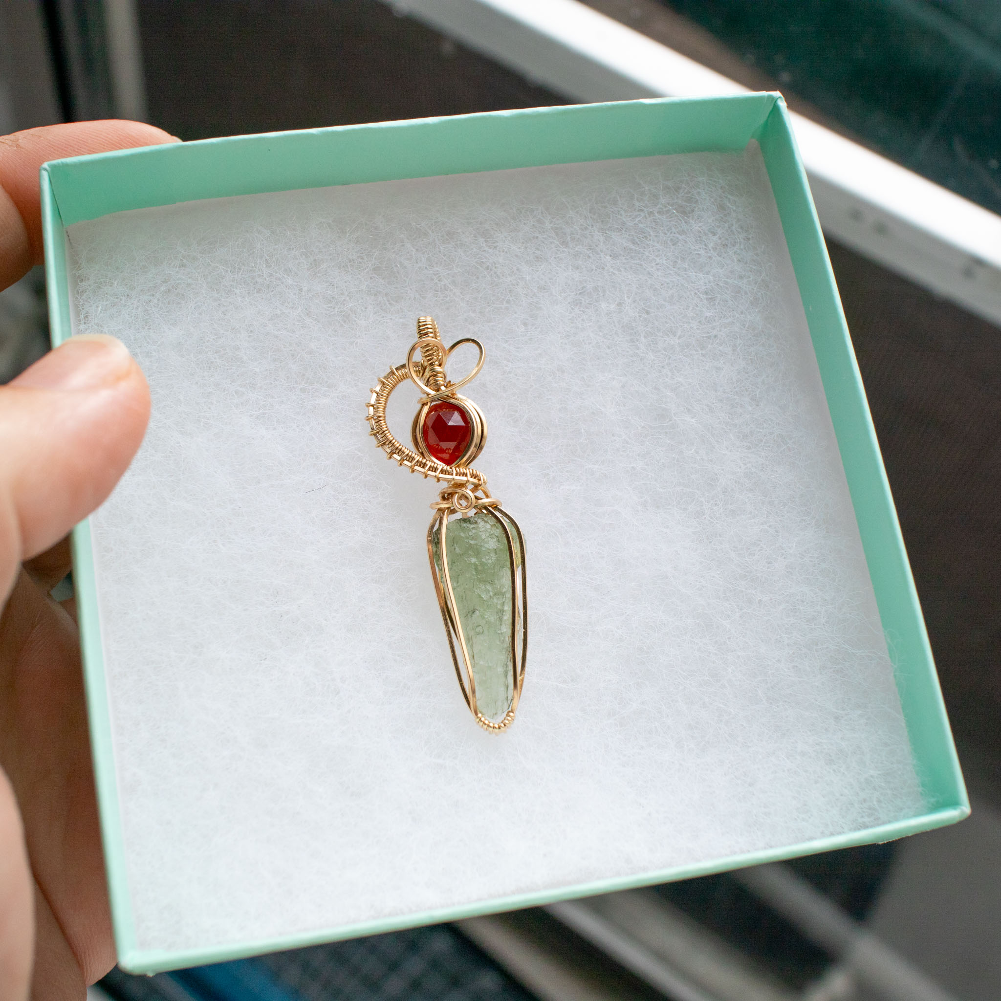 Moldavite with garnet pendant