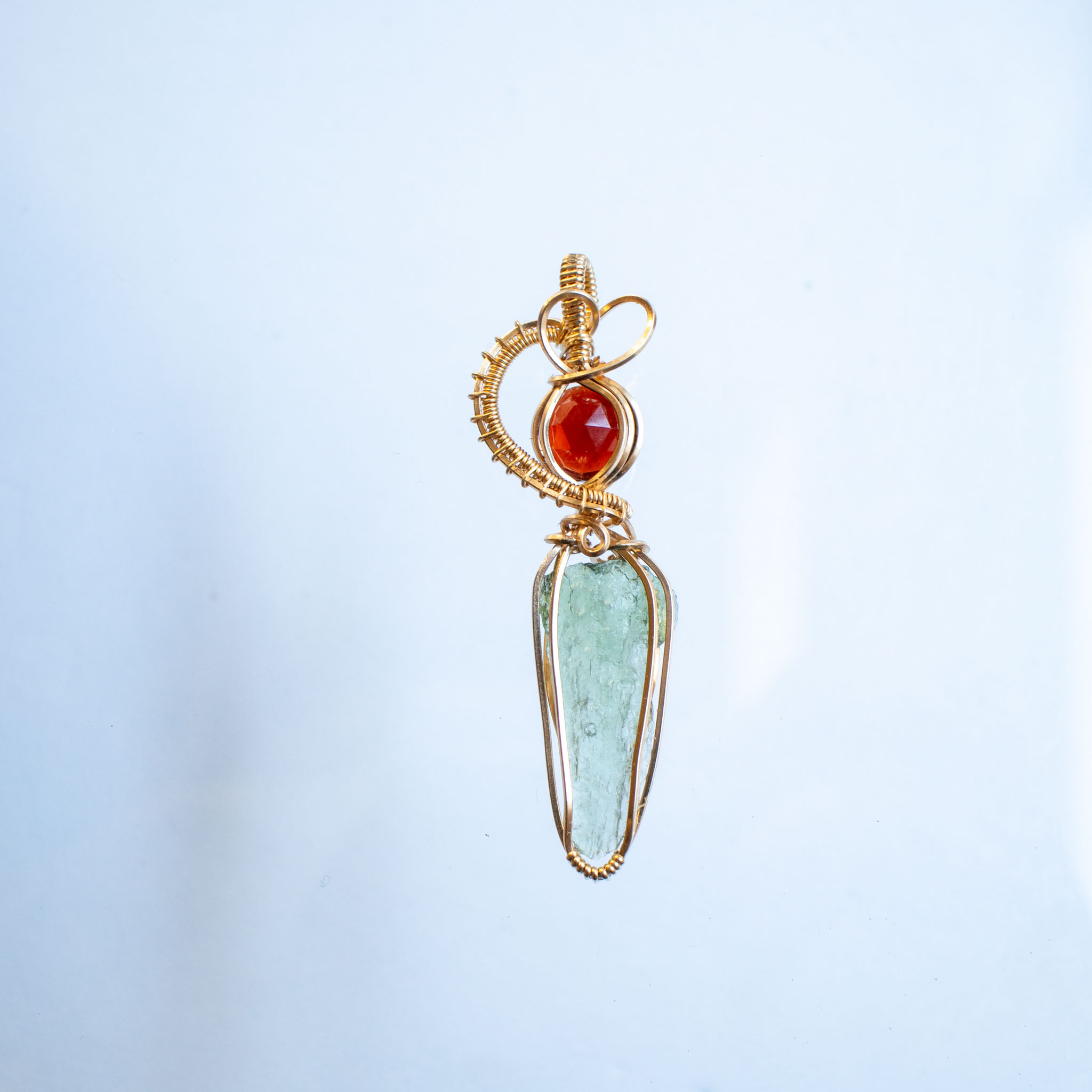 Moldavite with garnet pendant